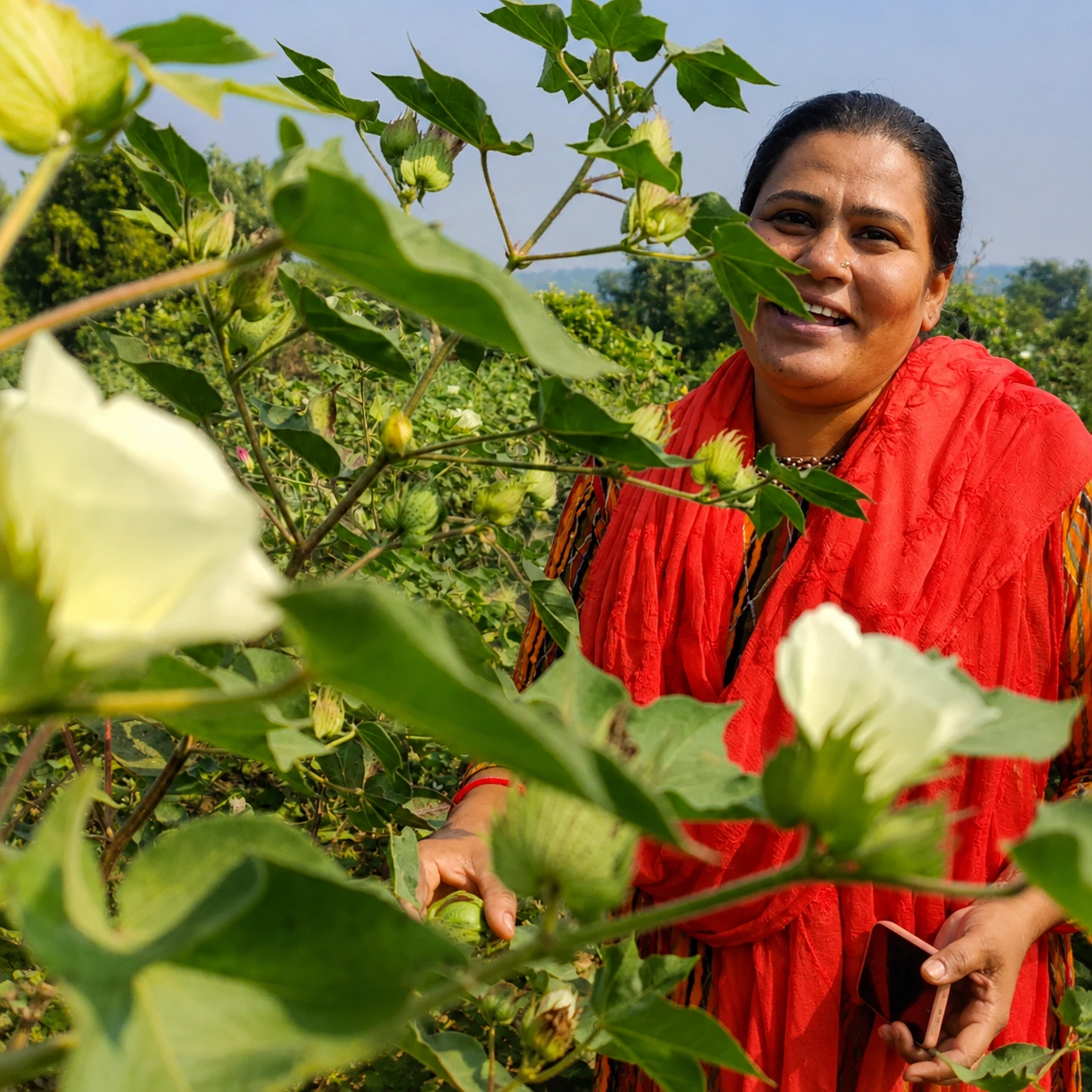 Woman farmer holding freshly harvested greens